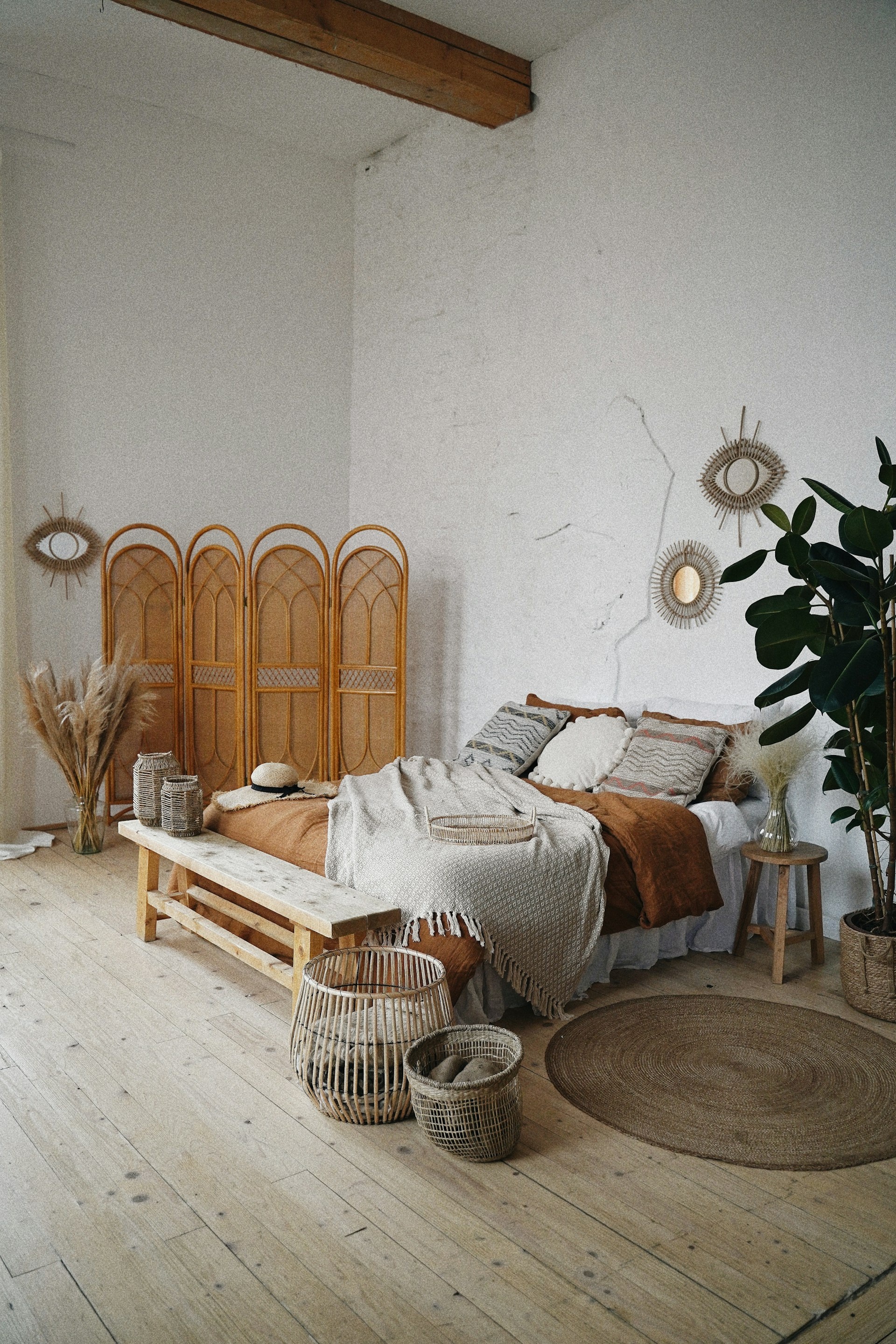 Renovated bedroom with exposed timber beam and natural textures